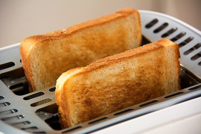 Lovely brown toast coming out of toaster